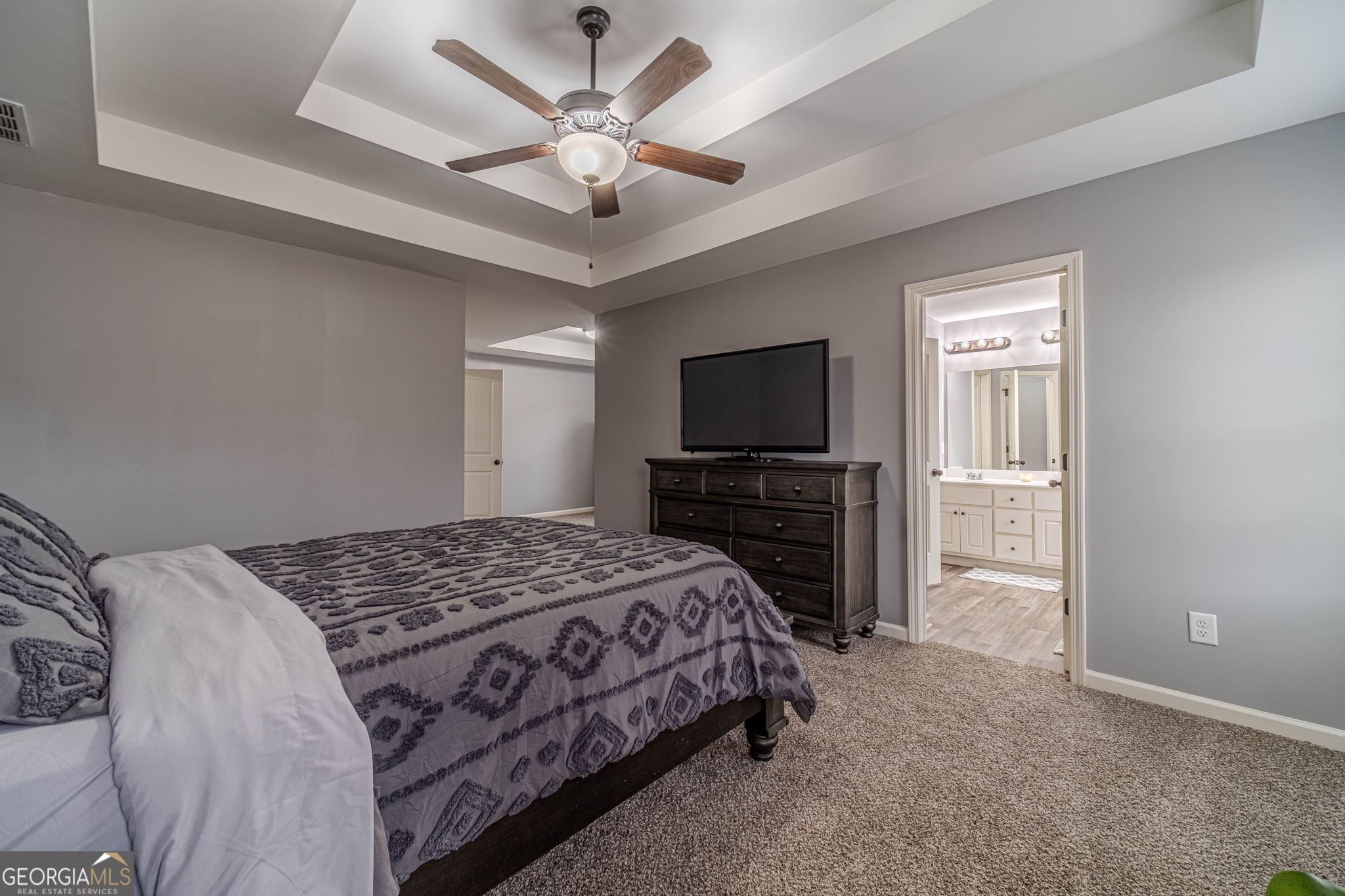 149 Peak Court Winder, GA 30680 - Photo 13 of 27 a bedroom with a large bed and a tv