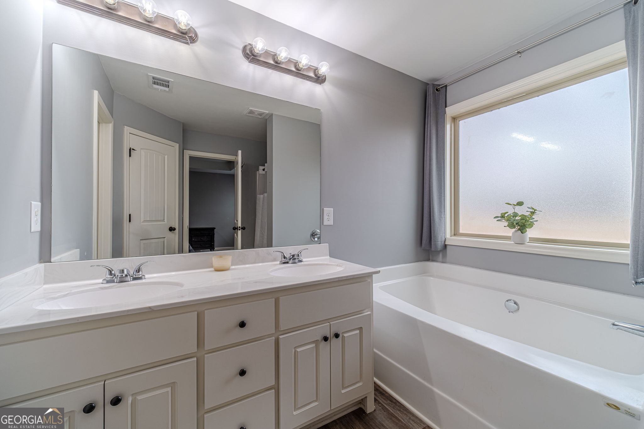 149 Peak Court Winder, GA 30680 - Photo 15 of 27 a bathroom with a tub a sink and mirror