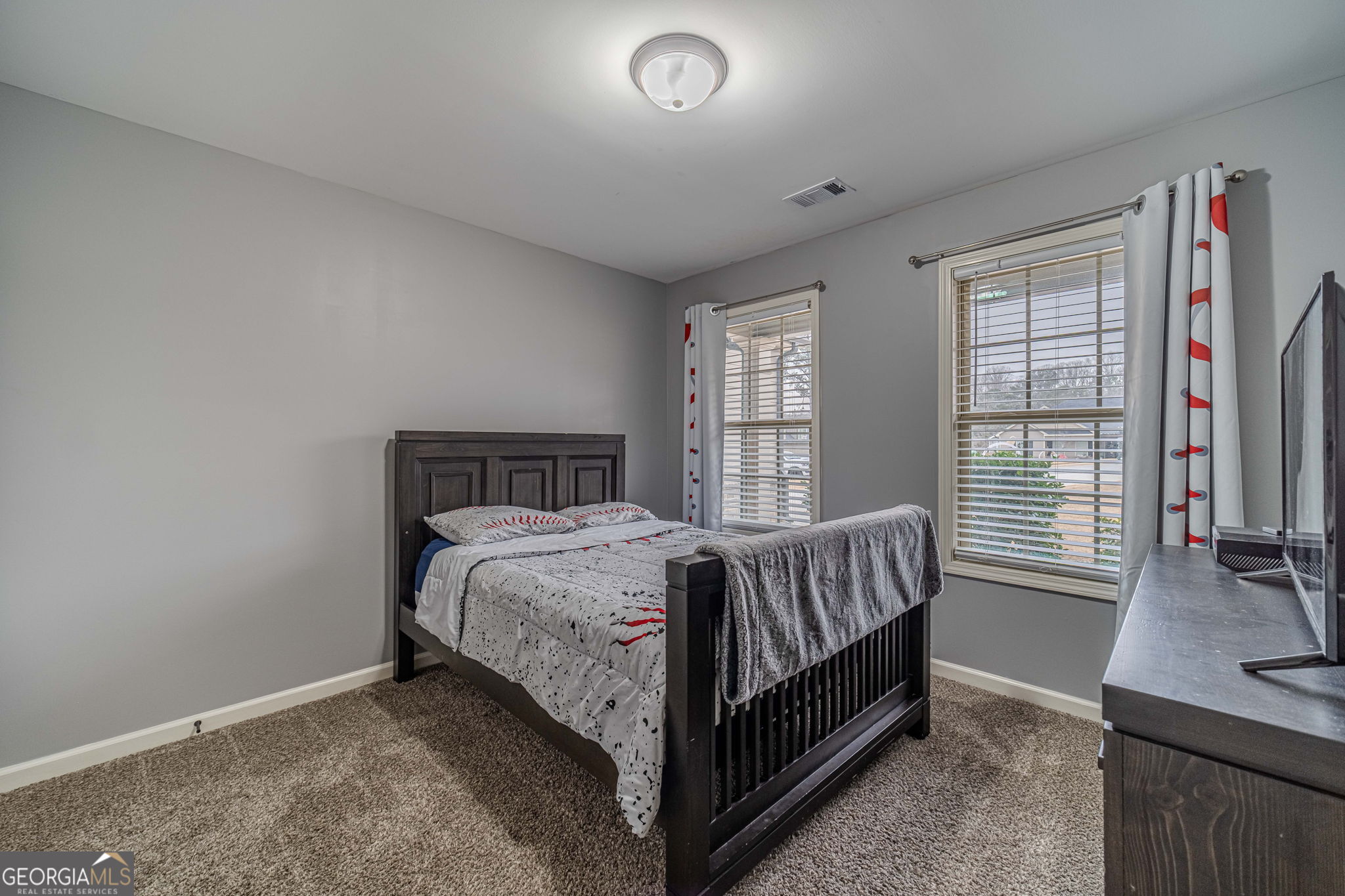 149 Peak Court Winder, GA 30680 - Photo 20 of 27 a bed sitting in a bedroom next to a window