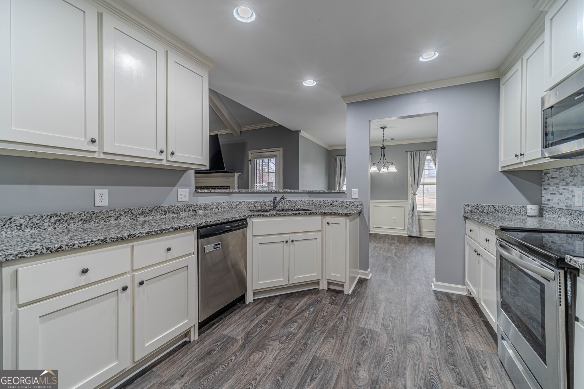149 Peak Court Winder, GA 30680 - Photo 7 of 27 a kitchen with granite countertop wooden cabinets and white appliances