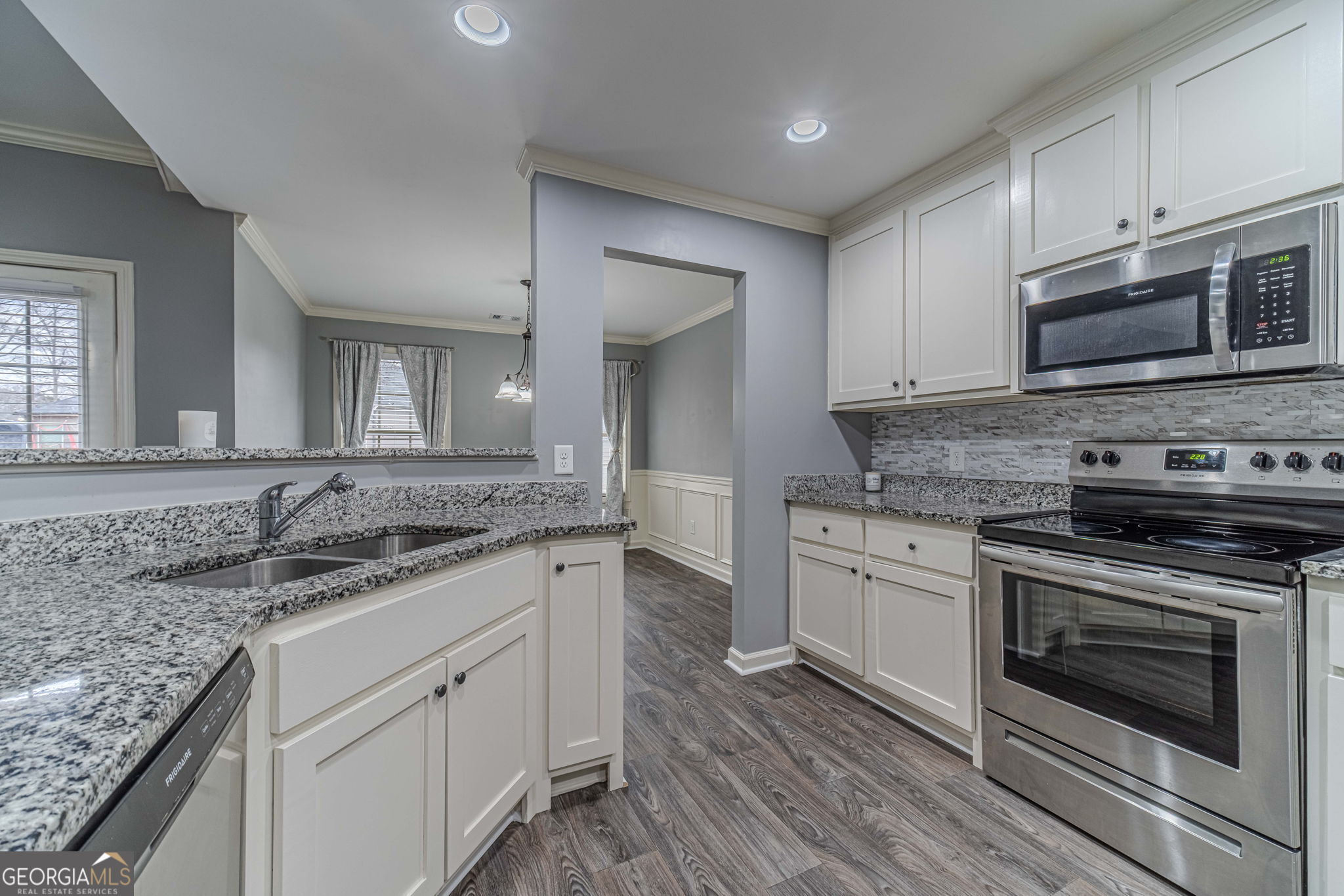149 Peak Court Winder, GA 30680 - Photo 8 of 27 a kitchen with stainless steel appliances granite countertop a stove microwave and cabinets