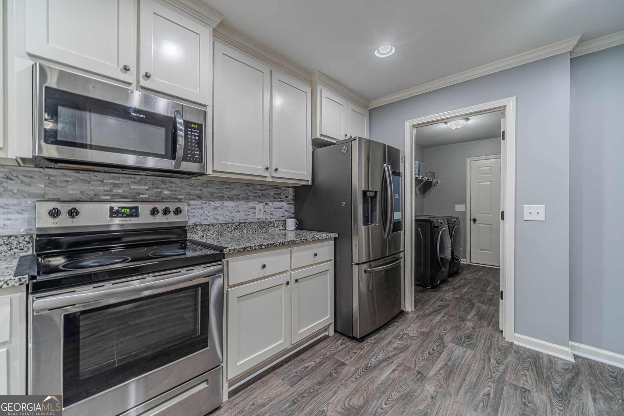 149 Peak Court Winder, GA 30680 - Photo 9 of 27 a kitchen with stainless steel appliances and wooden cabinets