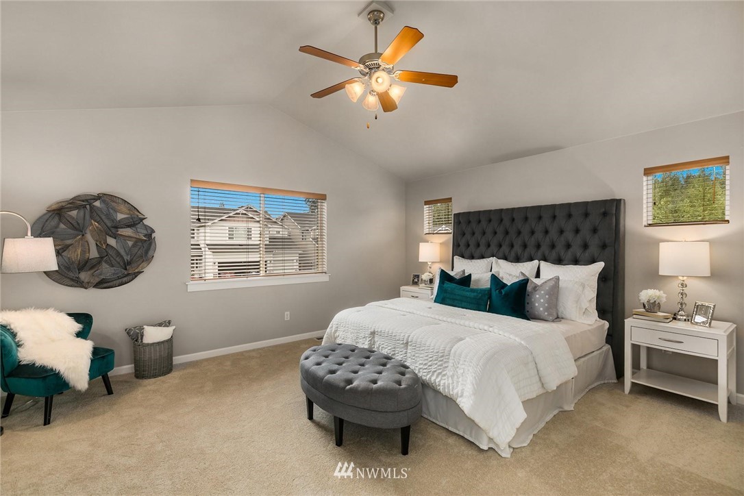 3731 226th Street Southeast Bothell, WA 98021 - Photo 14 of 30 a bedroom with a bed and a chandelier