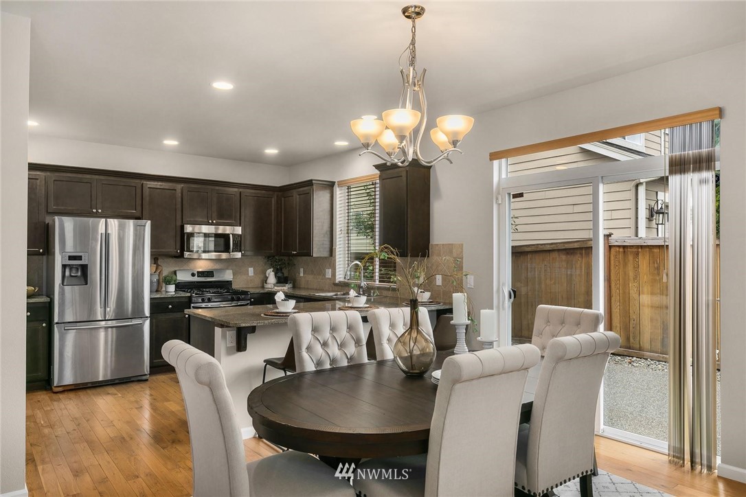 3731 226th Street Southeast Bothell, WA 98021 - Photo 9 of 30 a dining room with furniture a chandelier and kitchen view