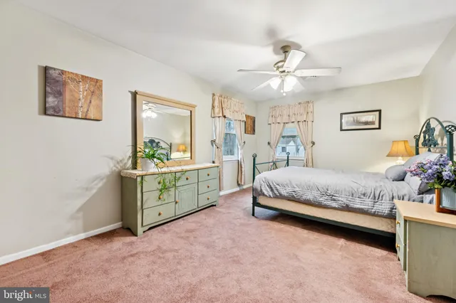 a bathroom with a toilet a sink and a mirror