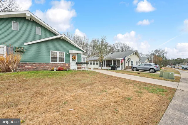 a front view of a house with yard and green space