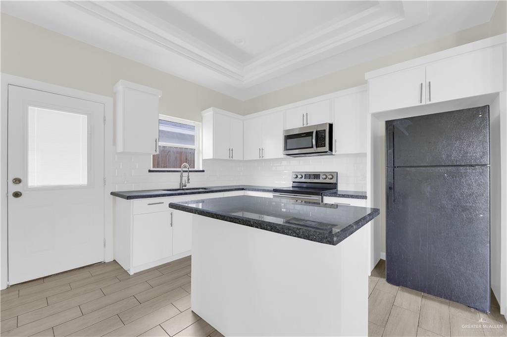 409 Rafael Drive San Juan, TX 78589 - Photo 11 of 20 a kitchen with a refrigerator stove and sink