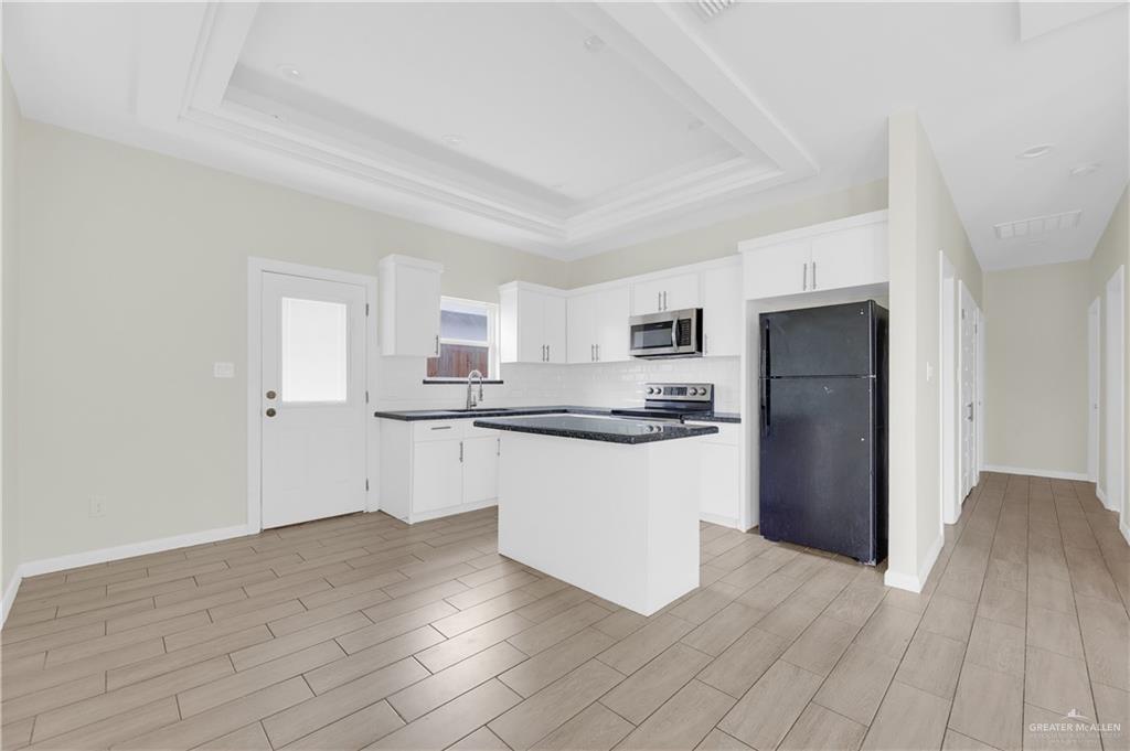 409 Rafael Drive San Juan, TX 78589 - Photo 12 of 20 a kitchen with stainless steel appliances a refrigerator sink and microwave
