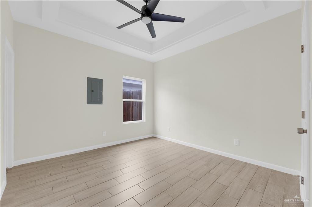 409 Rafael Drive San Juan, TX 78589 - Photo 17 of 20 a view of an empty room with wooden floor and a window