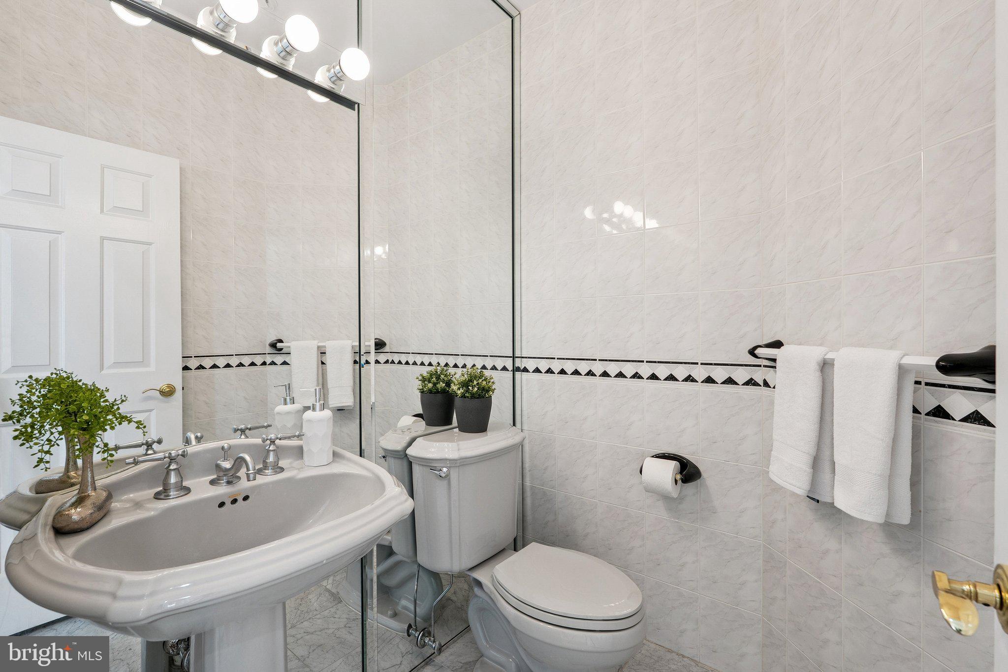 9309 Bells Mill Road Potomac, MD 20854 - Photo 19 of 38 a bathroom with a sink a toilet and shower