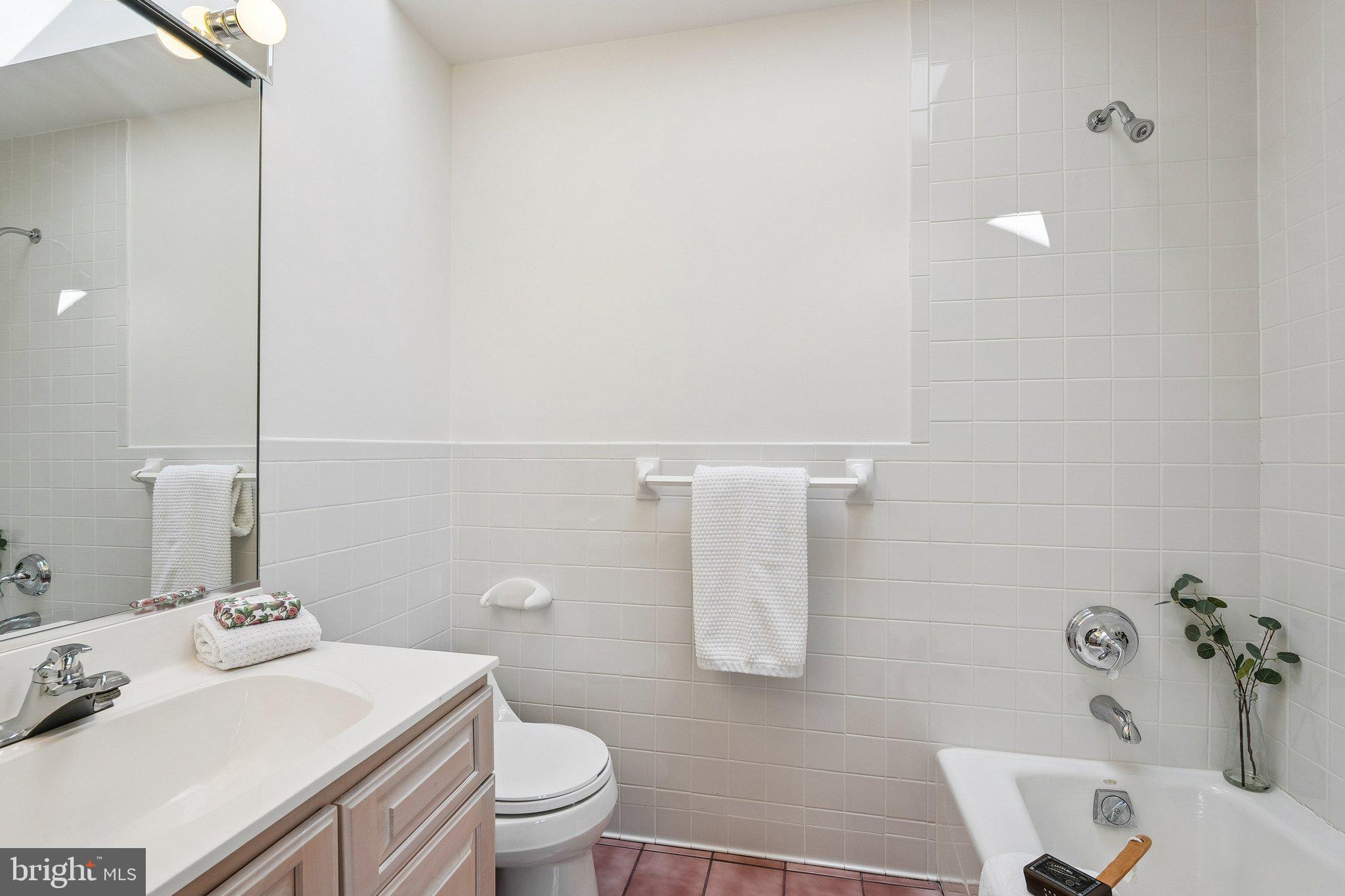 9309 Bells Mill Road Potomac, MD 20854 - Photo 24 of 38 a bathroom with a sink toilet and vanity
