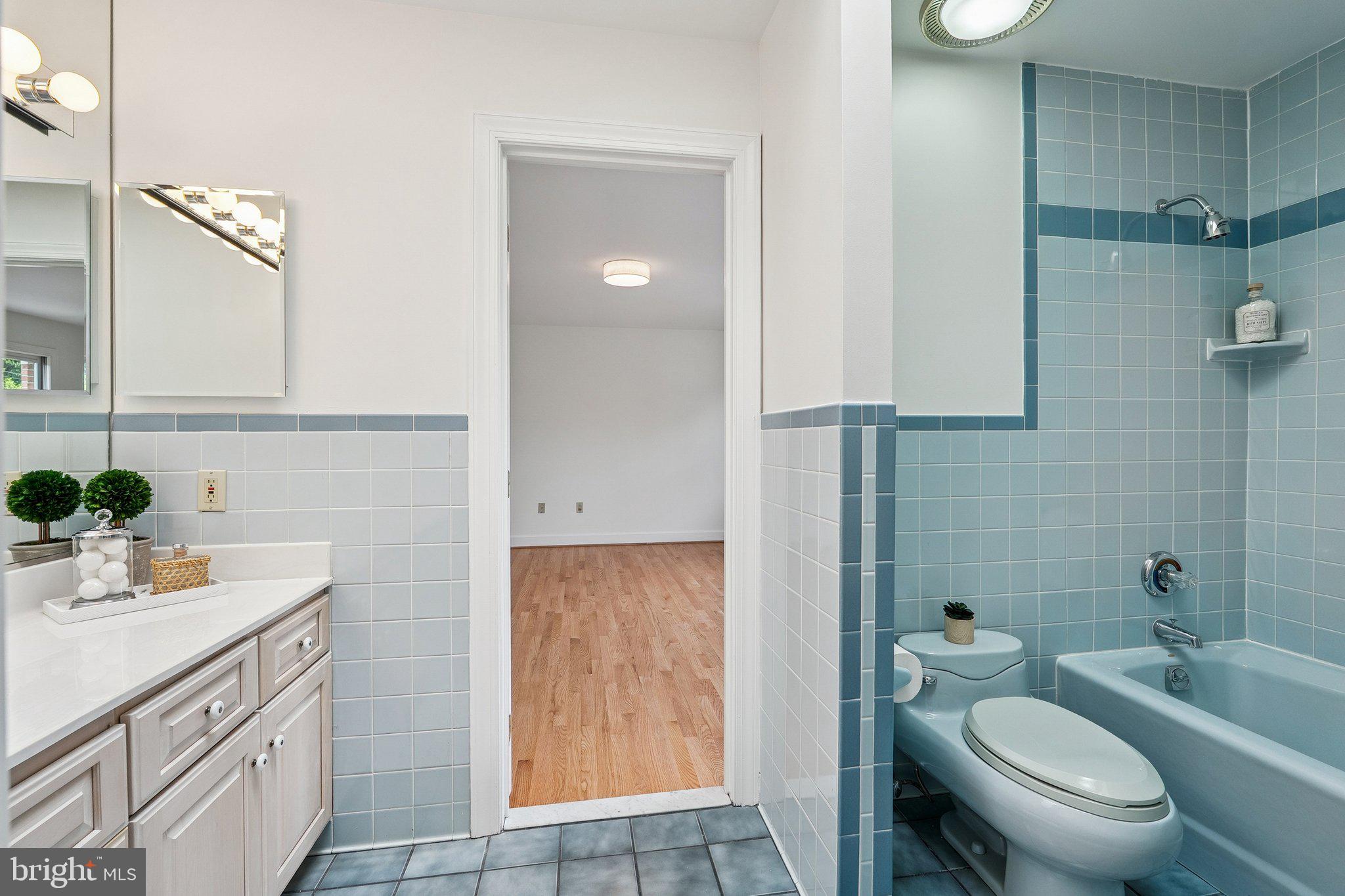 9309 Bells Mill Road Potomac, MD 20854 - Photo 26 of 38 a bathroom with a granite countertop toilet sink and mirror