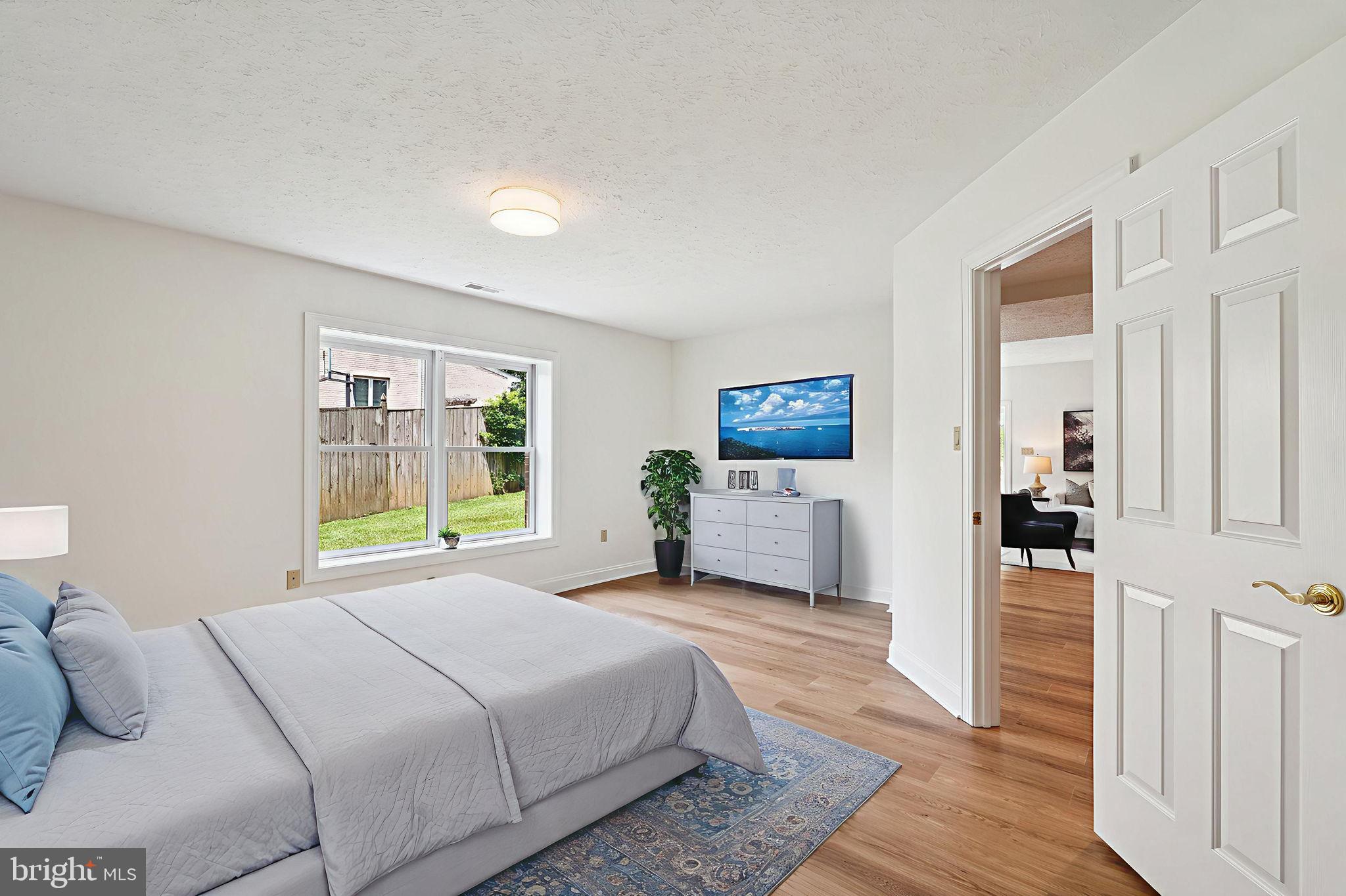 9309 Bells Mill Road Potomac, MD 20854 - Photo 31 of 38 a bedroom with a bed table and a window