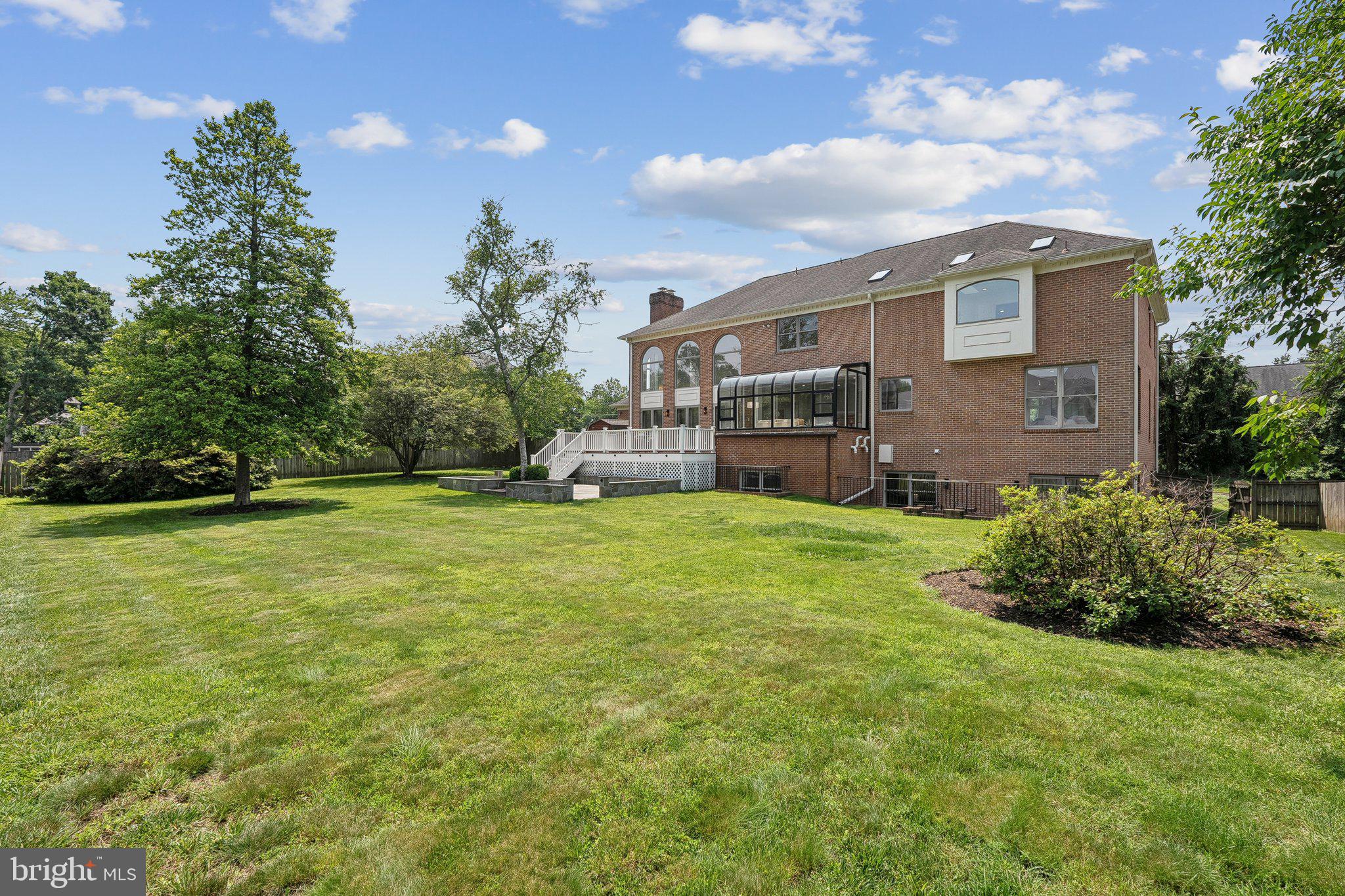 9309 Bells Mill Road Potomac, MD 20854 - Photo 34 of 38 a front view of house with yard and trees in the background