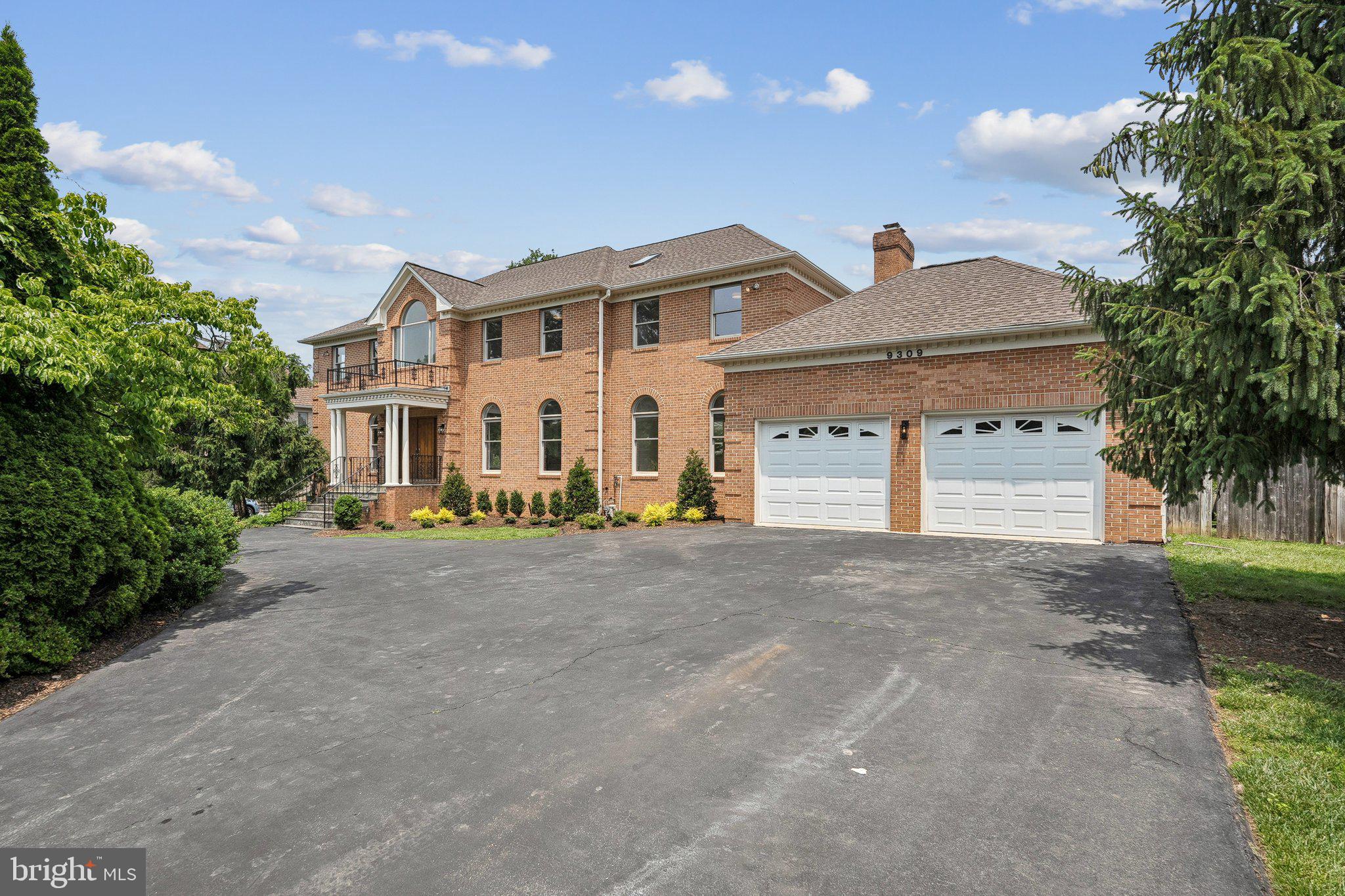 9309 Bells Mill Road Potomac, MD 20854 - Photo 35 of 38 a view of a white house with a outdoor space and a tree