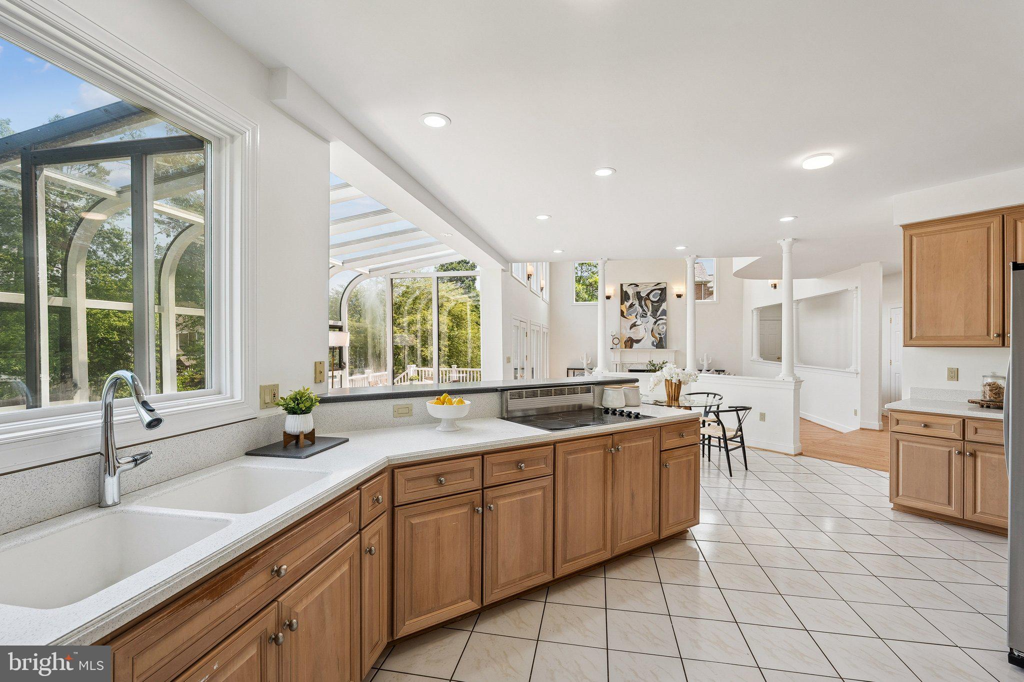 9309 Bells Mill Road Potomac, MD 20854 - Photo 9 of 38 a kitchen with stainless steel appliances a sink stove and cabinets