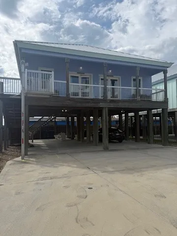 a view of a swimming pool with a patio and a yard