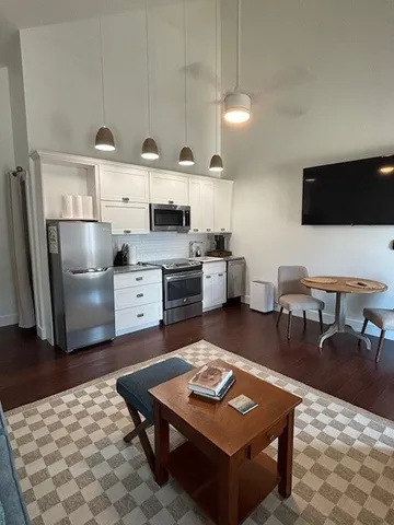 a kitchen with granite countertop cabinets and steel stainless steel appliances