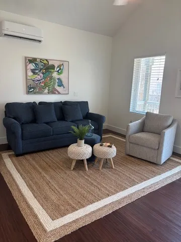 a kitchen with stainless steel appliances granite countertop a stove a sink a refrigerator dining table and chairs with wooden floor