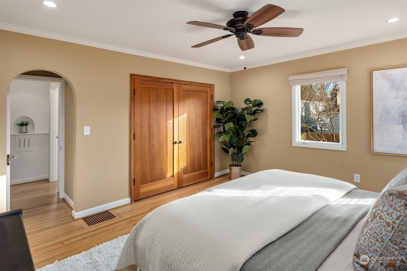 4335 Northeast 45th Street Seattle, WA 98105 - Photo 18 of 37 a bedroom with a large bed and a chandelier