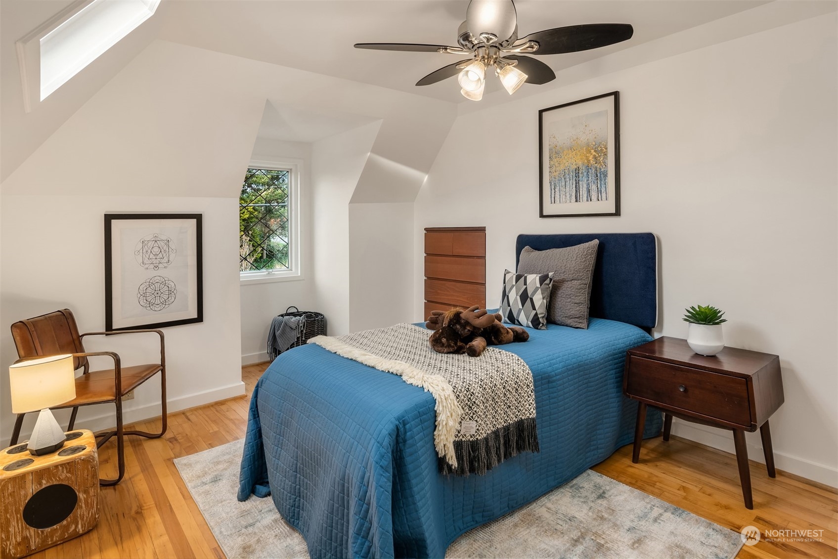 4335 Northeast 45th Street Seattle, WA 98105 - Photo 20 of 37 a bedroom with a bed a chair and a potted plant