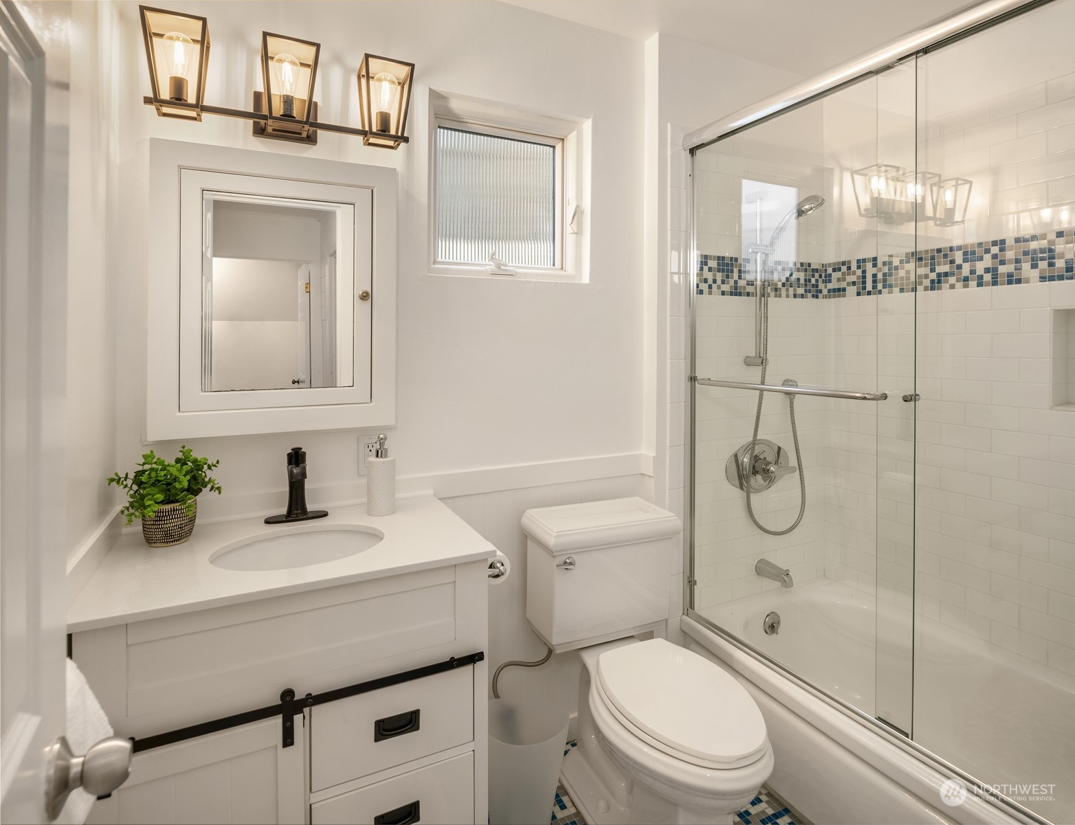 4335 Northeast 45th Street Seattle, WA 98105 - Photo 23 of 37 a bathroom with a granite countertop sink a toilet and shower