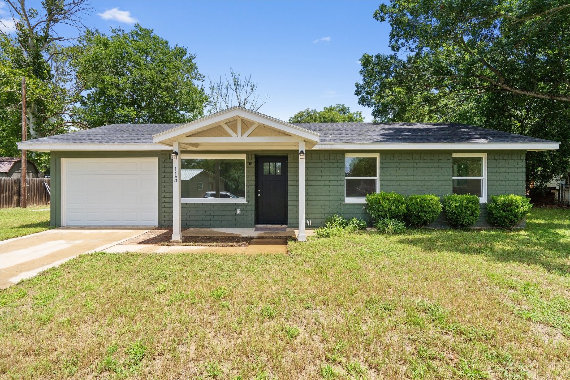 115 Sycamore Street Luling, TX 78648 - Photo 1 of 1 a front view of a house with a garden