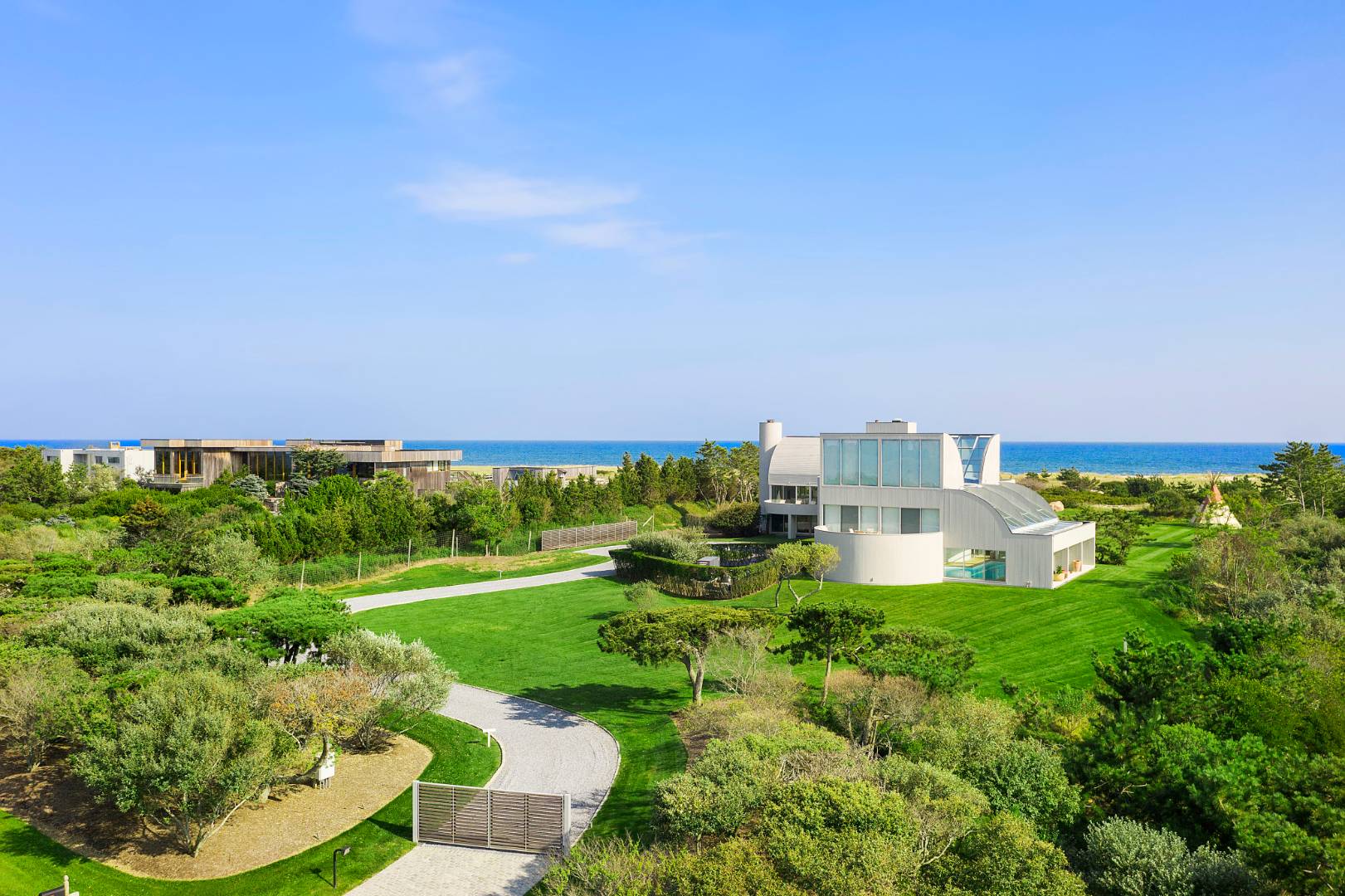 Undisclosed Address Southampton, NY 11968 - Photo 2 of 43 a view of a house with a yard and sitting area