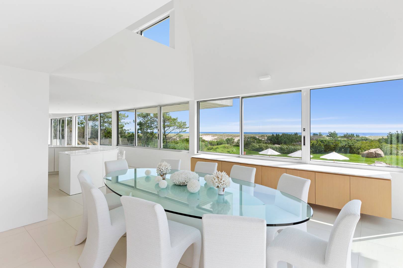 Undisclosed Address Southampton, NY 11968 - Photo 12 of 43 a dining room with furniture a flat screen tv and a floor to ceiling window