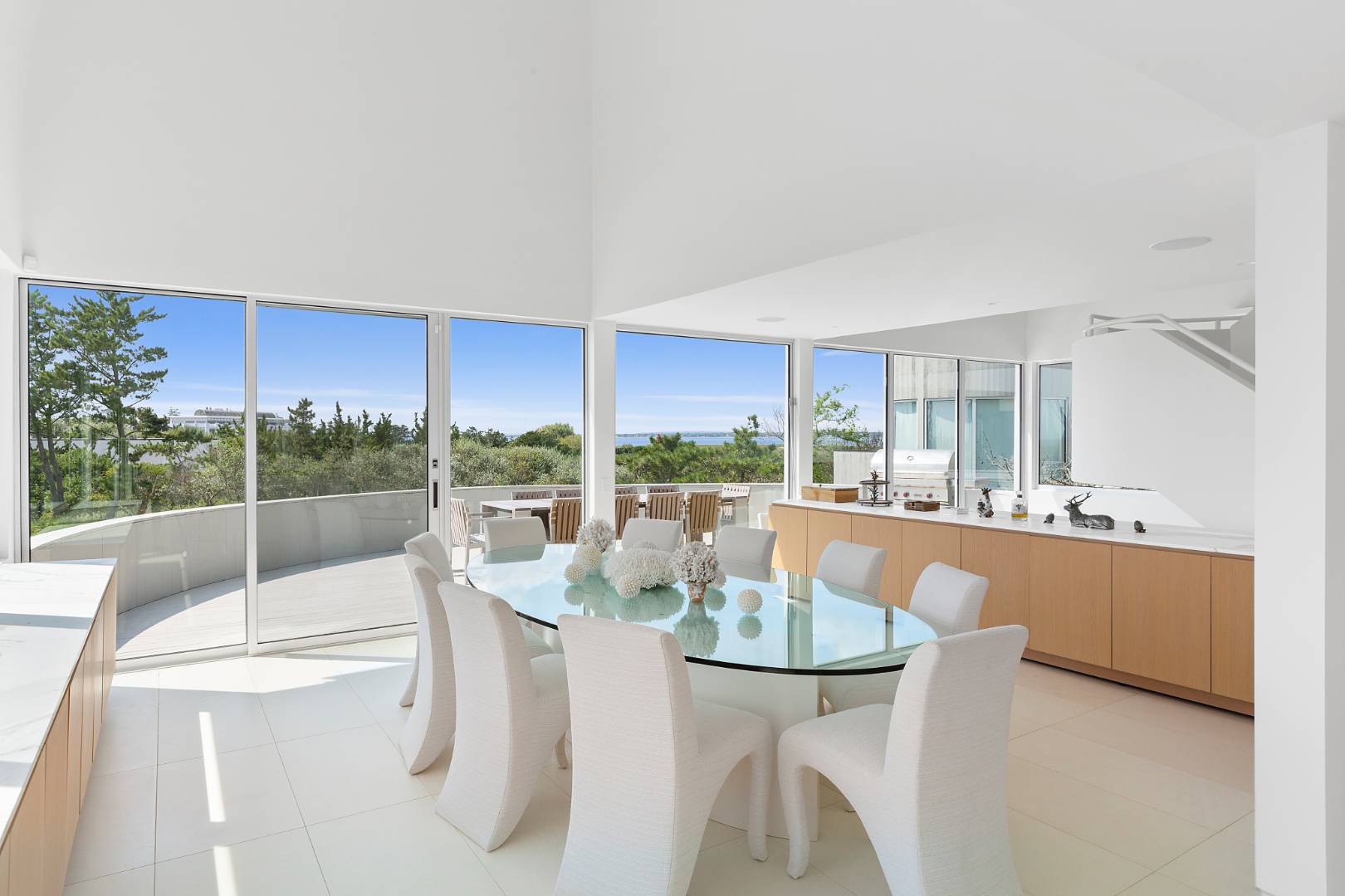 Undisclosed Address Southampton, NY 11968 - Photo 13 of 43 a dining room with furniture a large window and a kitchen view