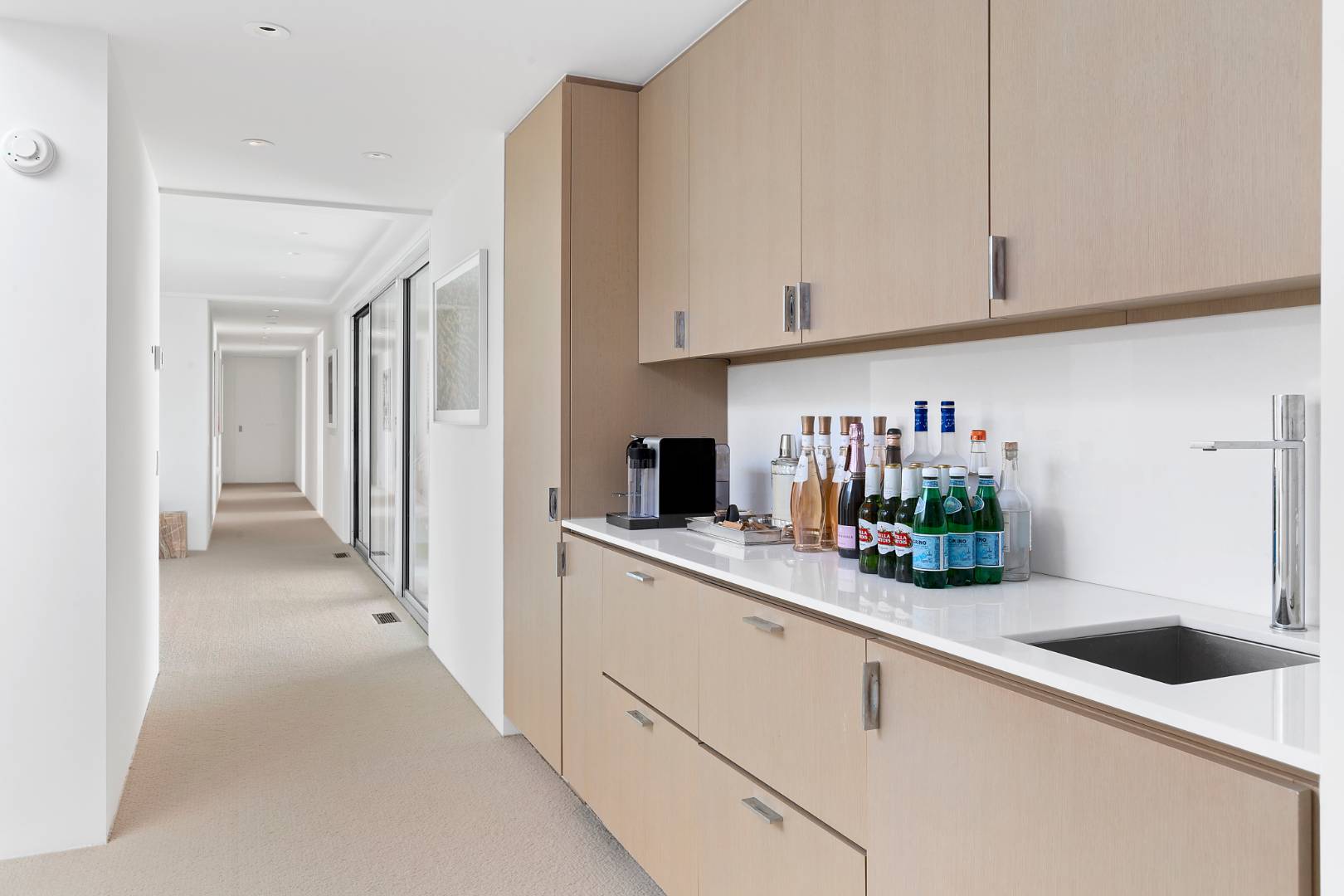 Undisclosed Address Southampton, NY 11968 - Photo 16 of 43 a kitchen with white cabinets and sink