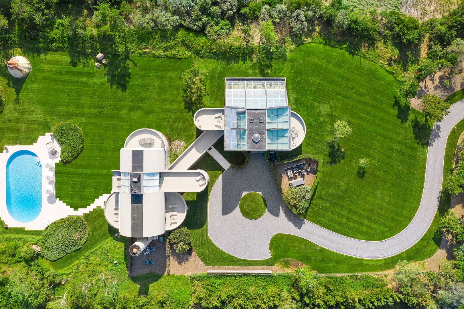 Undisclosed Address Southampton, NY 11968 - Photo 41 of 43 a backyard of a house with table and chairs