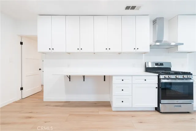 a kitchen with white cabinets and white appliances
