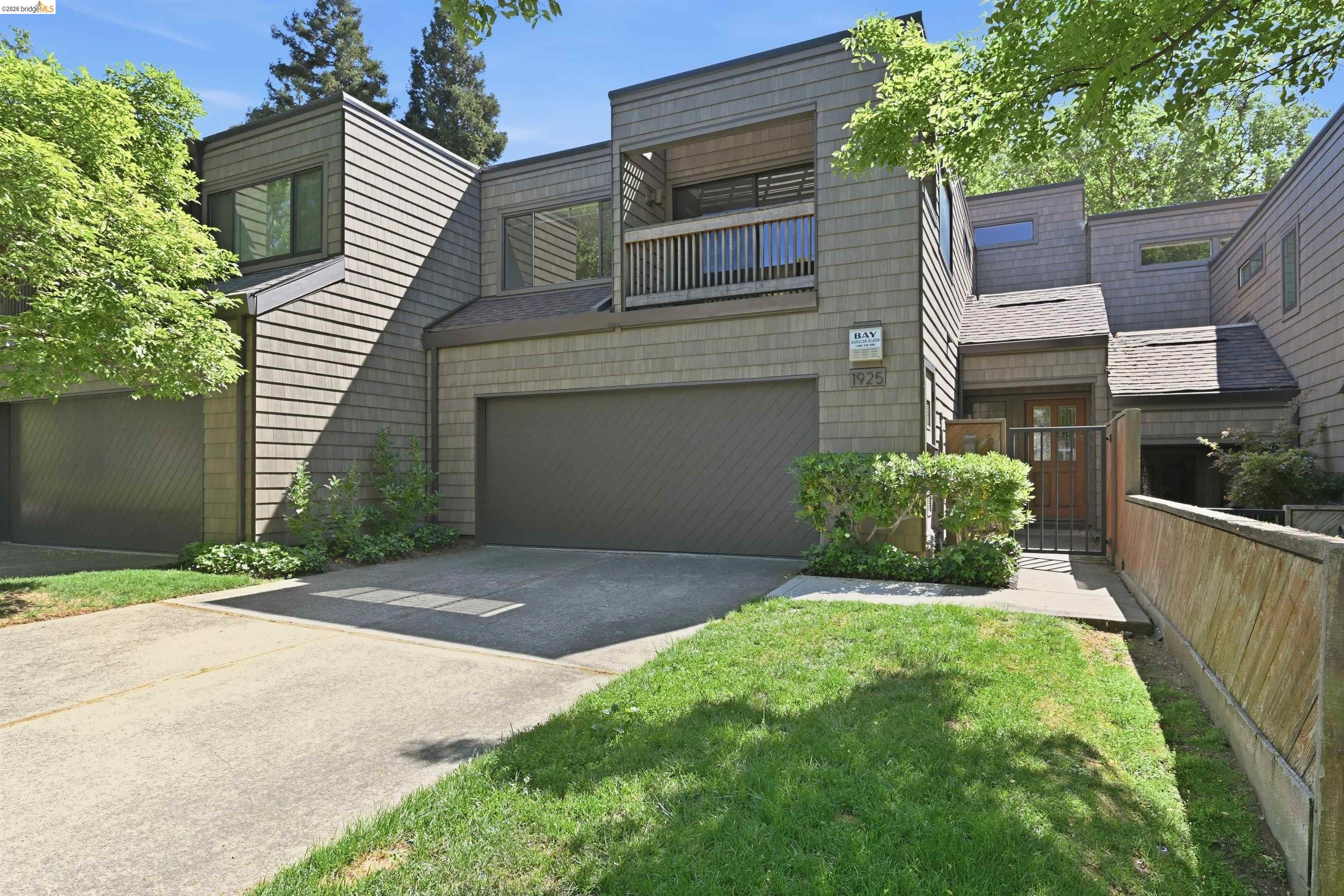 1925 Piper Ridge Court Walnut Creek, CA 94597 - Photo 1 of 27 View of front facade with concrete driveway, a balcony, and an attached garage