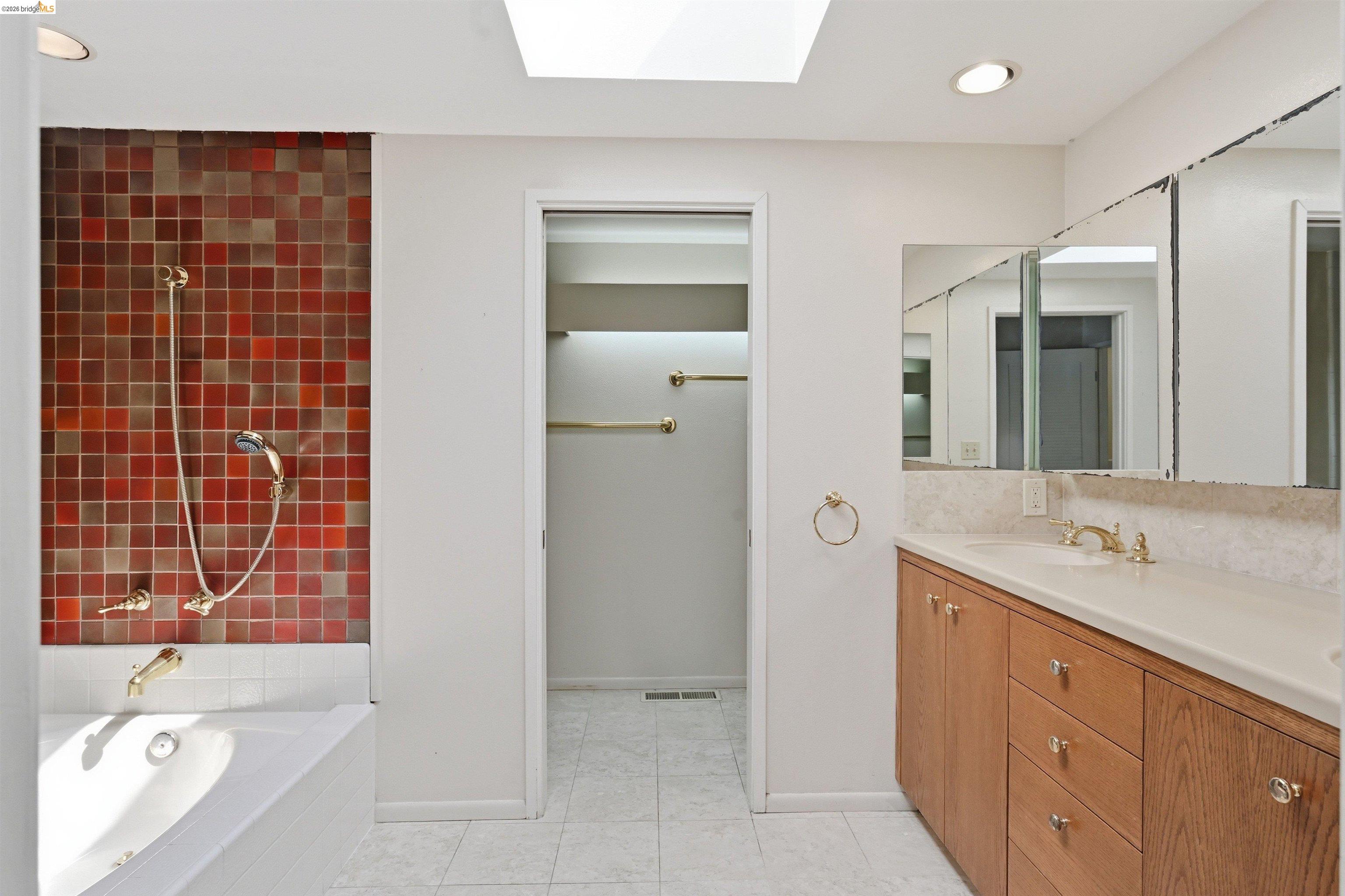1925 Piper Ridge Court Walnut Creek, CA 94597 - Photo 14 of 27 Bathroom with a skylight, tiled shower / bath combo, vanity, recessed lighting, and light tile patterned floors
