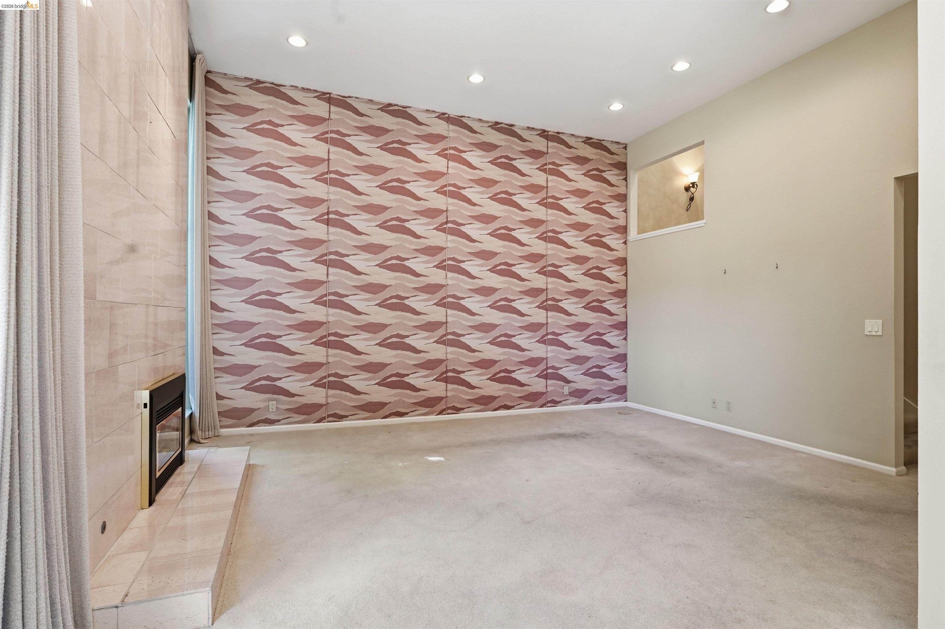 1925 Piper Ridge Court Walnut Creek, CA 94597 - Photo 7 of 27 Spare room featuring an accent wall, wallpapered walls, recessed lighting, light colored carpet, and a premium fireplace