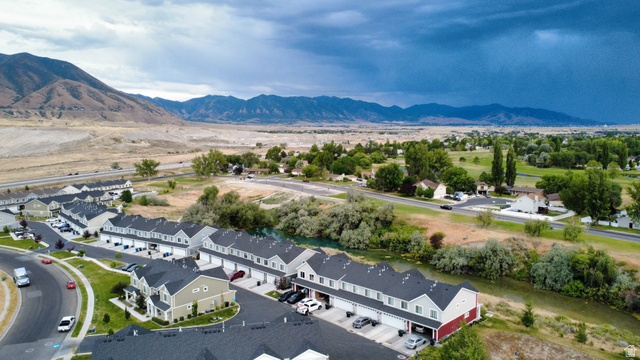 562 Hal Street, Unit 152 Tooele, UT 84074 - Photo 39 of 44 Aerial perspective showcasing a community of multi-story townhomes with dark shingle roofs and various exterior finishes