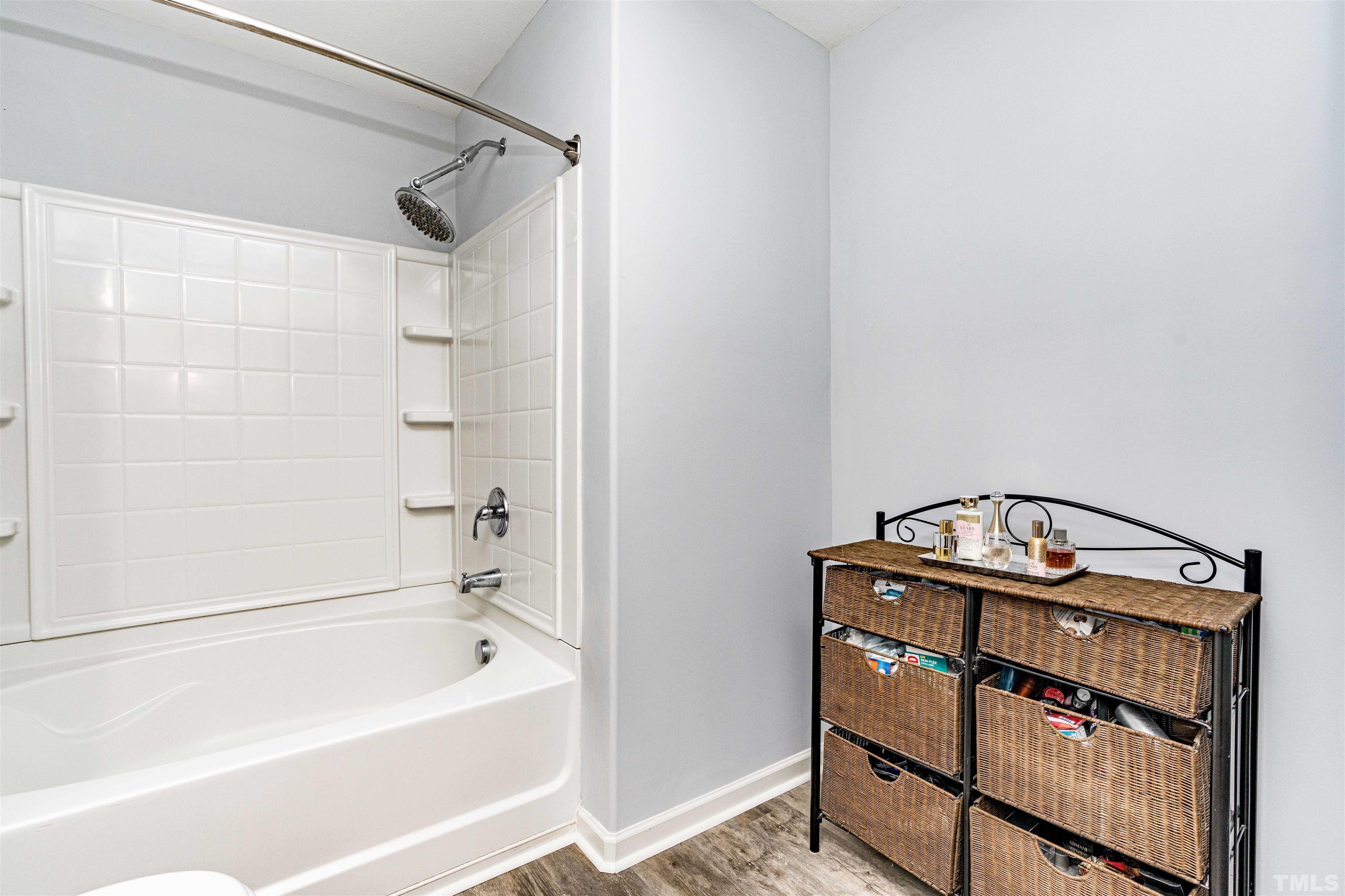 3902 Evans Drive Raleigh, NC 27610 - Photo 23 of 31 a bathroom with a bathtub and a shower