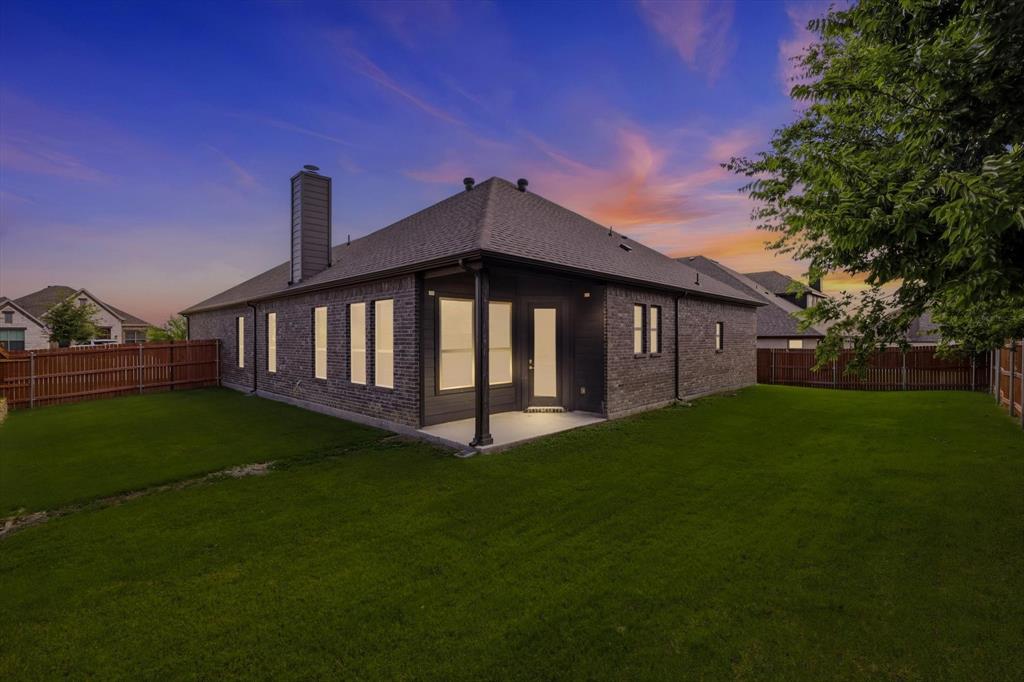 4017 Alpine Street Midlothian, TX 76065 - Photo 2 of 37 Spacious backyard with dark brick exterior and a covered patio