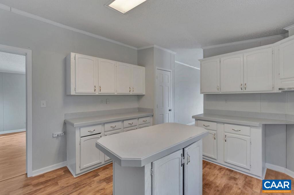 867 Scotts Bottom Road Dillwyn, VA 23936 - Photo 11 of 29 a kitchen with a sink cabinets and wooden floor