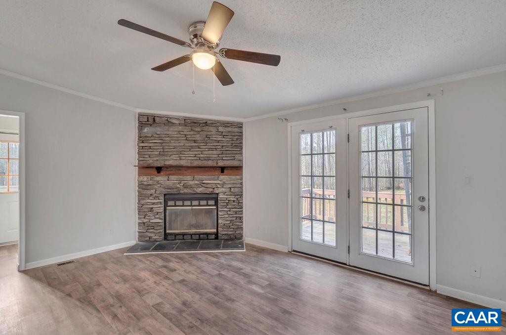 867 Scotts Bottom Road Dillwyn, VA 23936 - Photo 14 of 29 a view of an empty room with a fireplace and a window