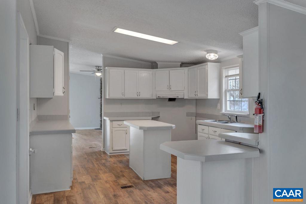 867 Scotts Bottom Road Dillwyn, VA 23936 - Photo 8 of 29 a kitchen with a sink a refrigerator and cabinets