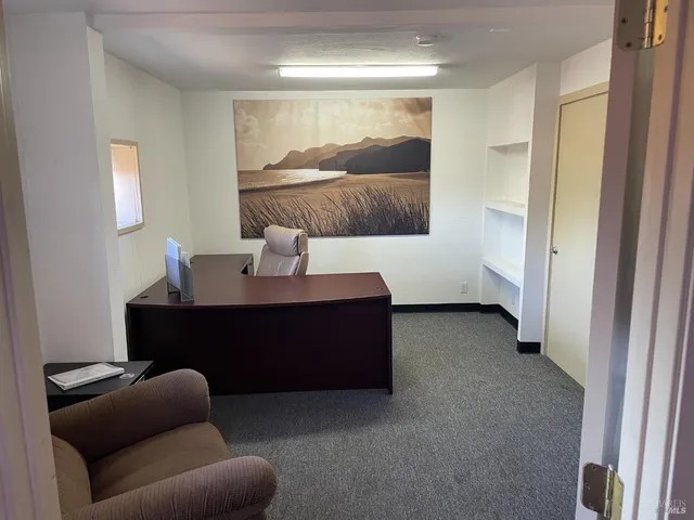 a living room with furniture and a lamp