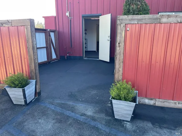 a view of a house with backyard and potted plants