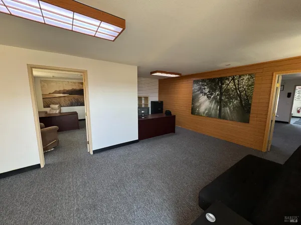 a view of hallway with livingroom and furniture