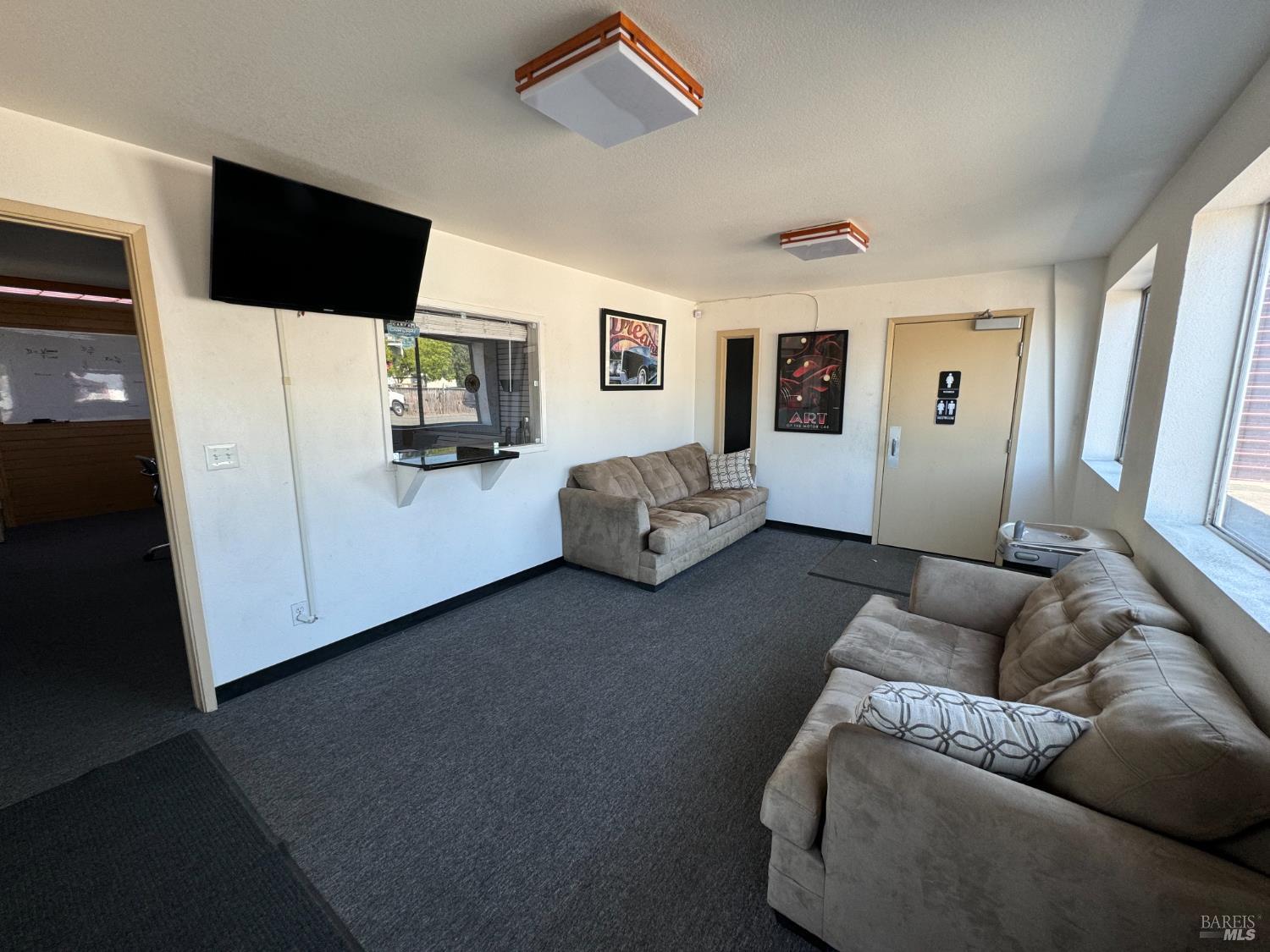 3753 Santa Rosa Avenue, Unit B Santa Rosa, CA 95407 - Photo 32 of 34 a living room with furniture and a flat screen tv