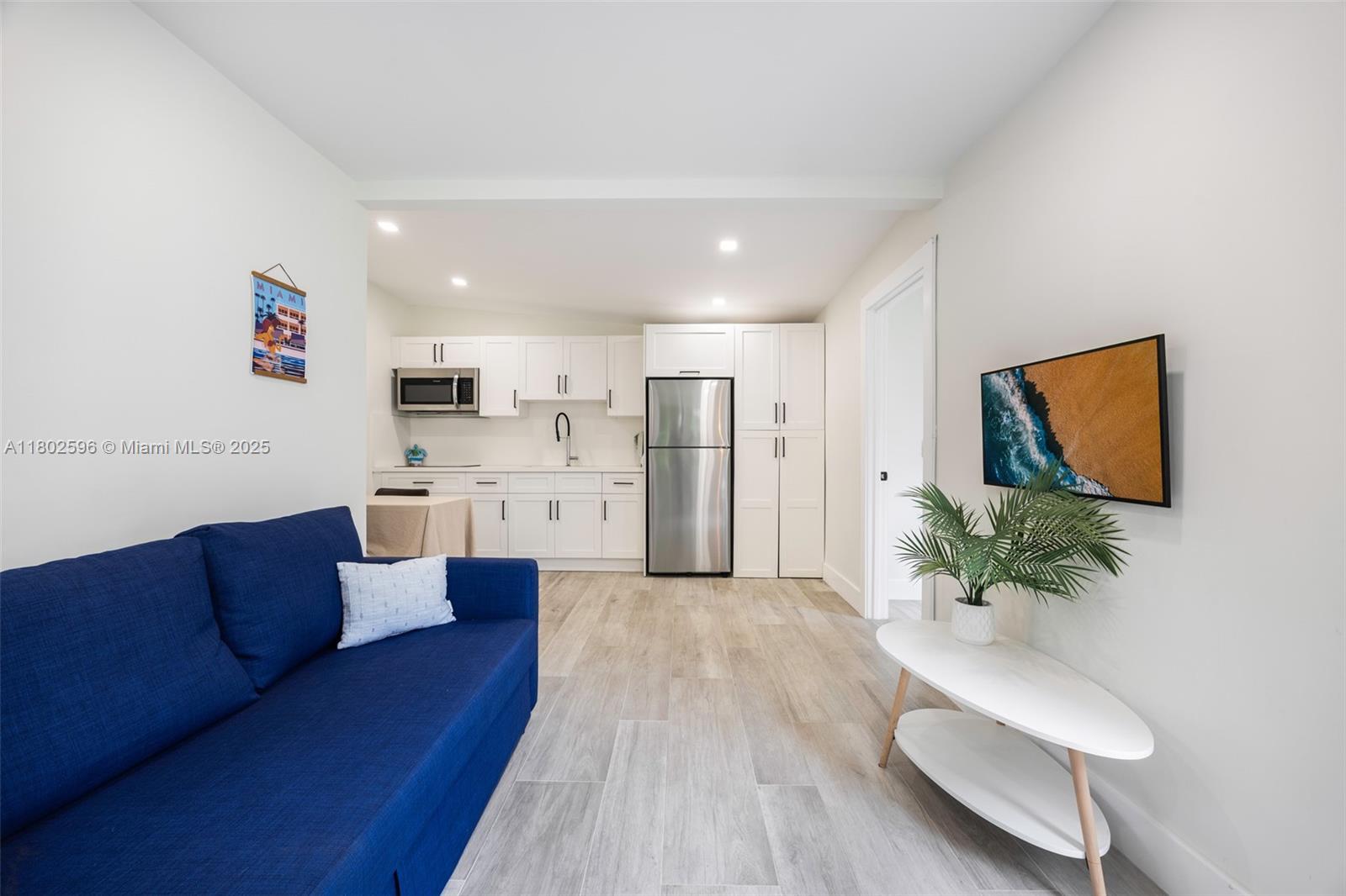 2478 Inagua Avenue Coconut Grove, FL 33133 - Photo 12 of 40 a living room with furniture and a potted plant