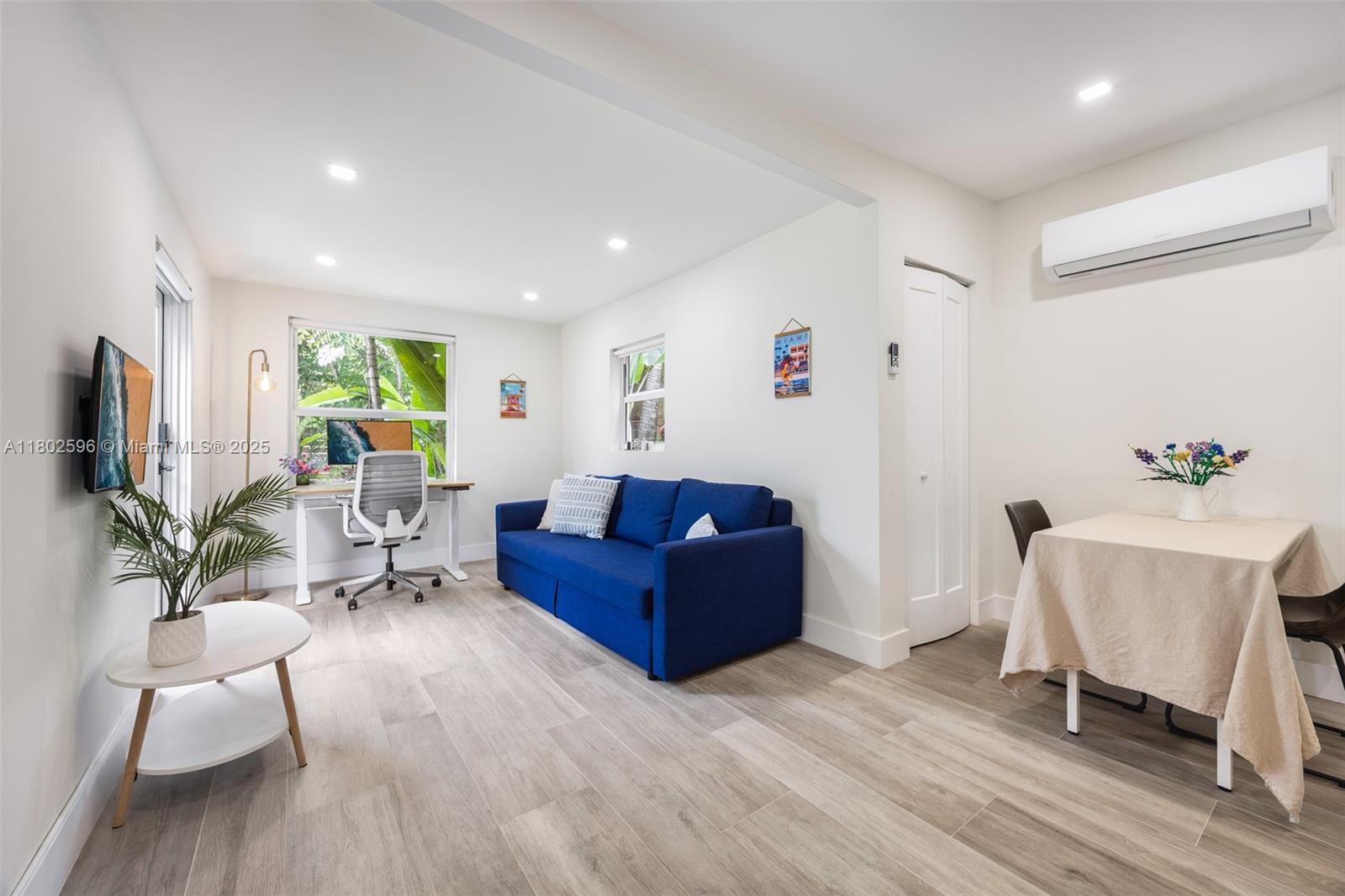 2478 Inagua Avenue Coconut Grove, FL 33133 - Photo 13 of 40 a living room with furniture or wooden floor and a flat screen tv