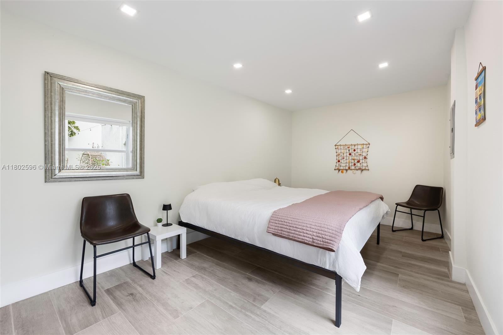 2478 Inagua Avenue Coconut Grove, FL 33133 - Photo 17 of 40 a bedroom with a bed and a chair