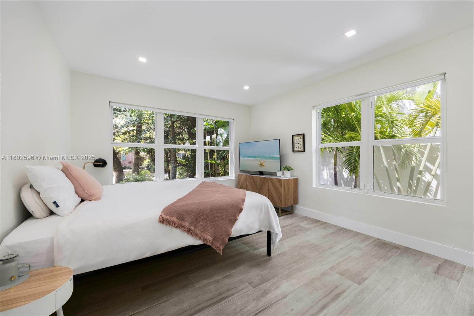 2478 Inagua Avenue Coconut Grove, FL 33133 - Photo 22 of 40 a bedroom with a bed and a large window